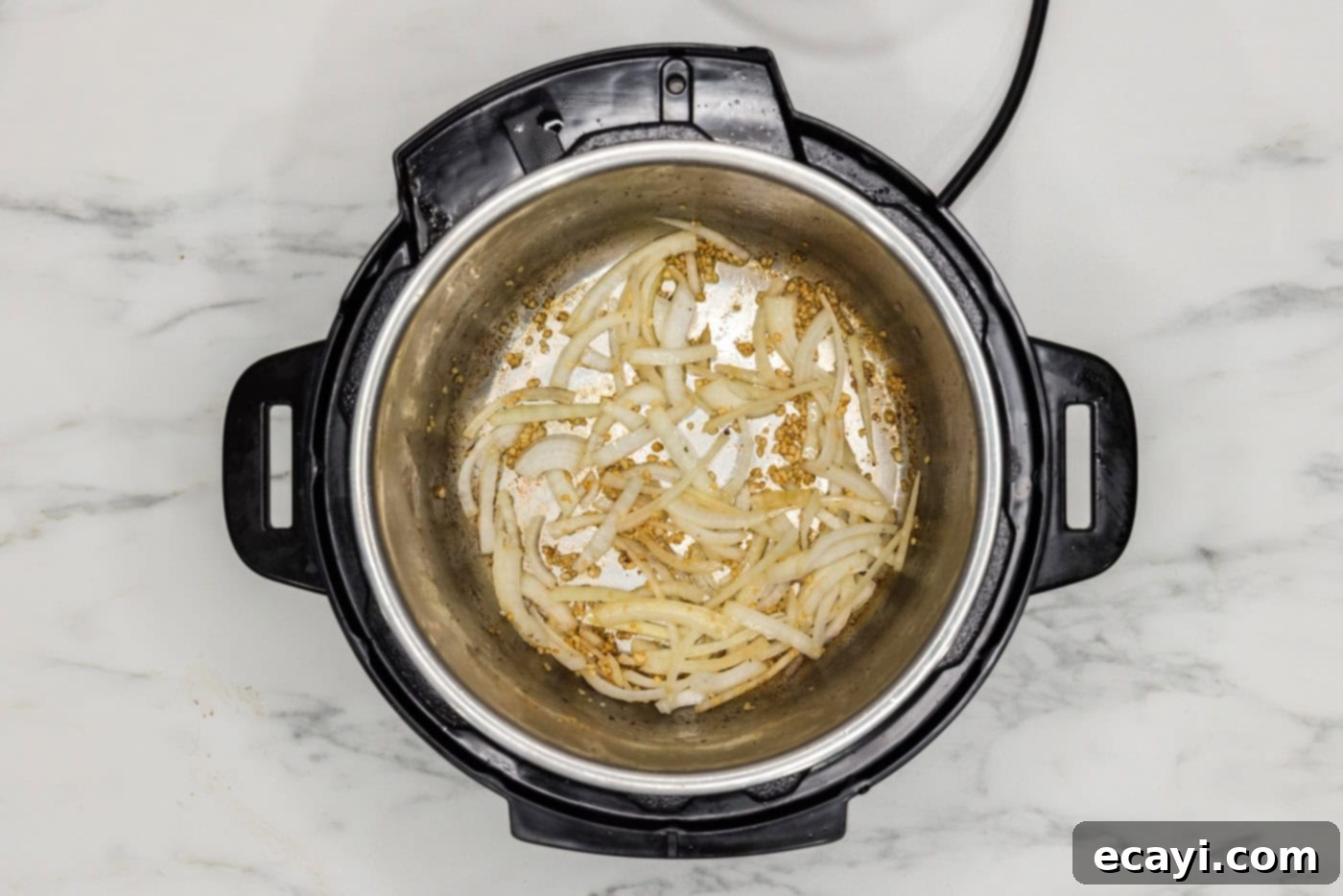 Easy Instant Pot Beef Tips and Gravy 7 sauteeing onions and garlic in the instant pot