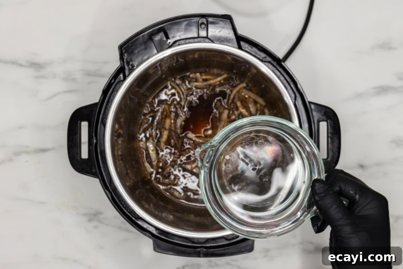 Easy Instant Pot Beef Tips and Gravy 8 adding water to instant pot with onions, worcestershire sauce, beef base, and soy sauce