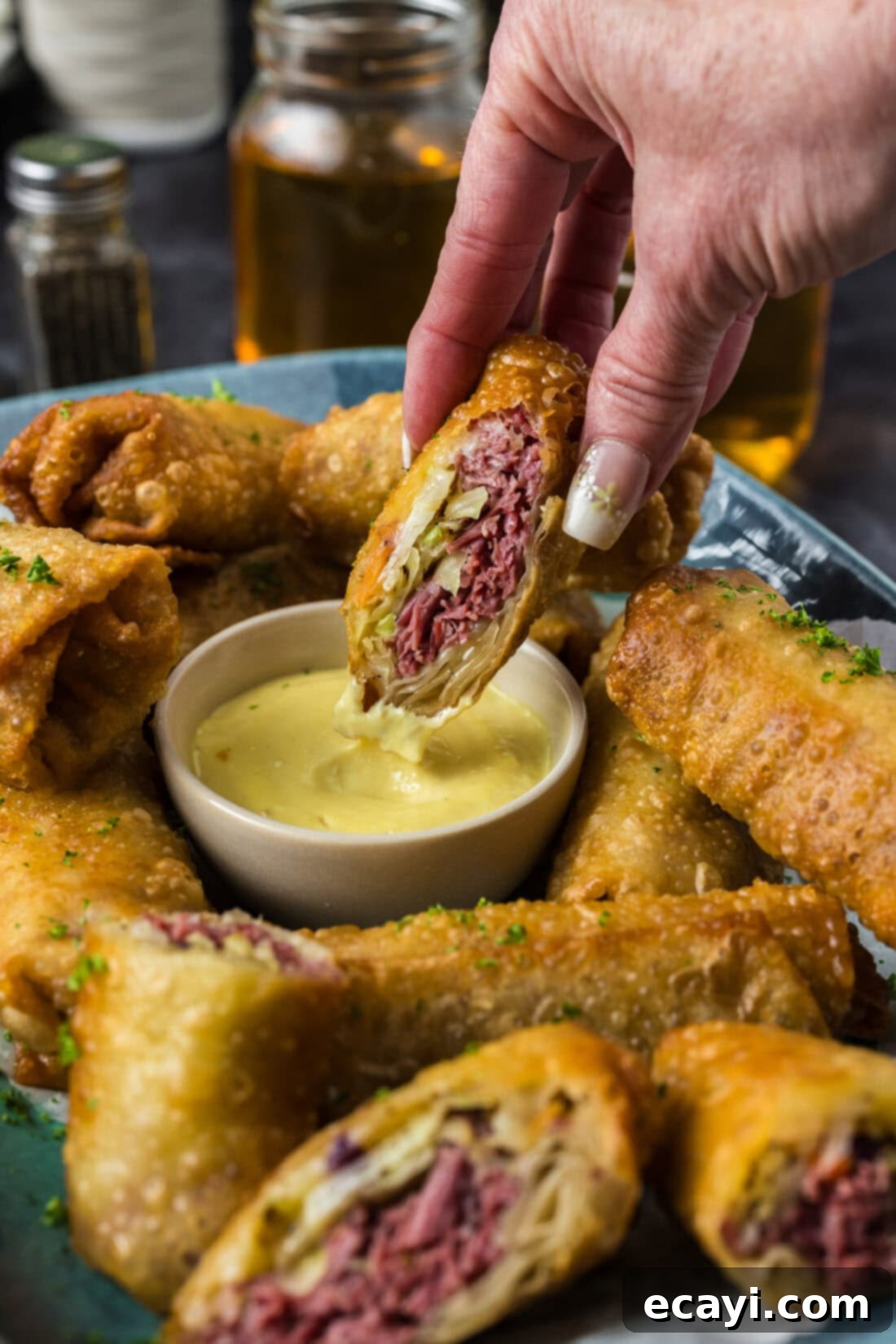 Crispy Corned Beef Egg Rolls 3 Half a Corned Beef Egg Roll dipping in dressing