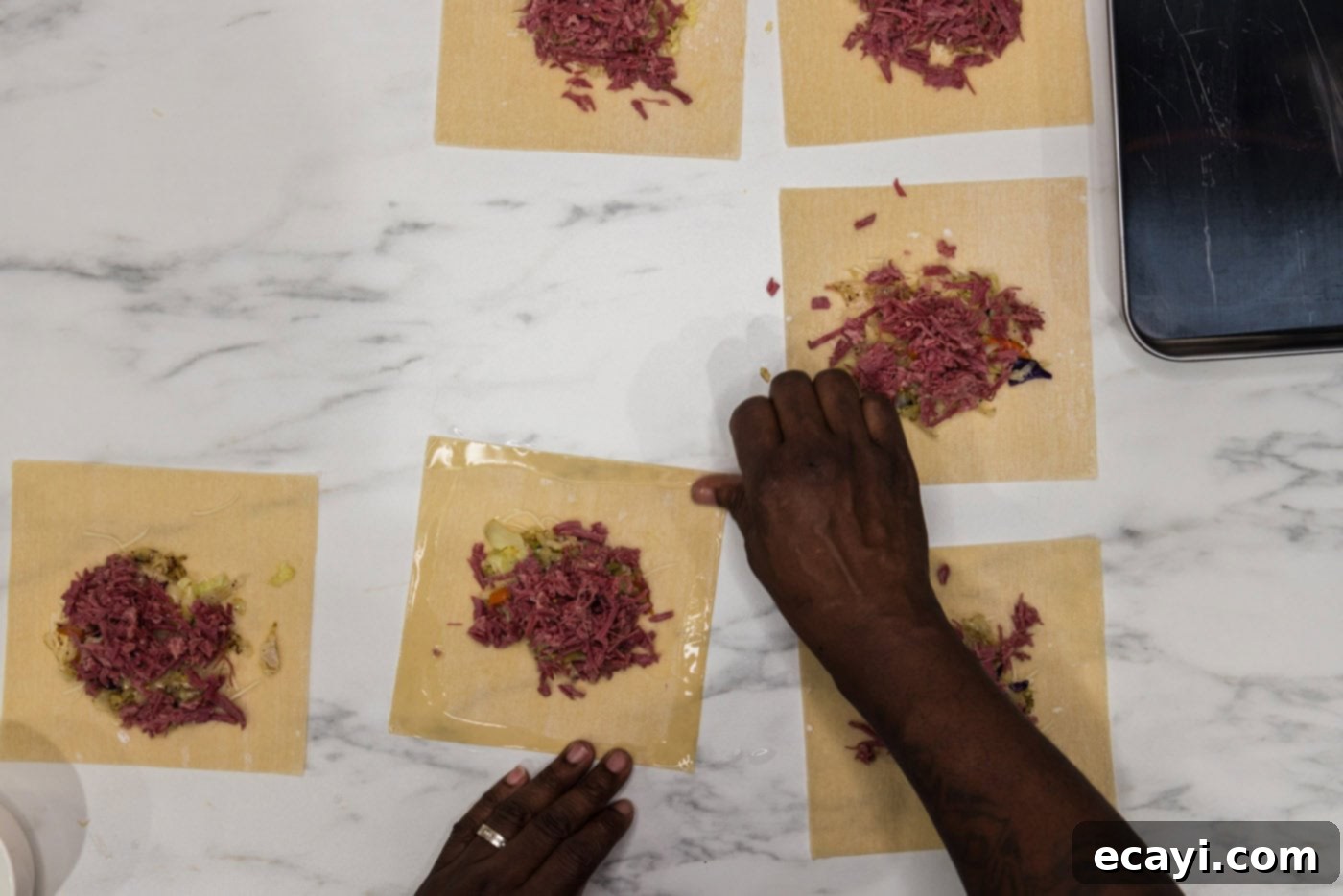 Crispy Corned Beef Egg Rolls 9 wetting the edges of egg roll wrappers with water