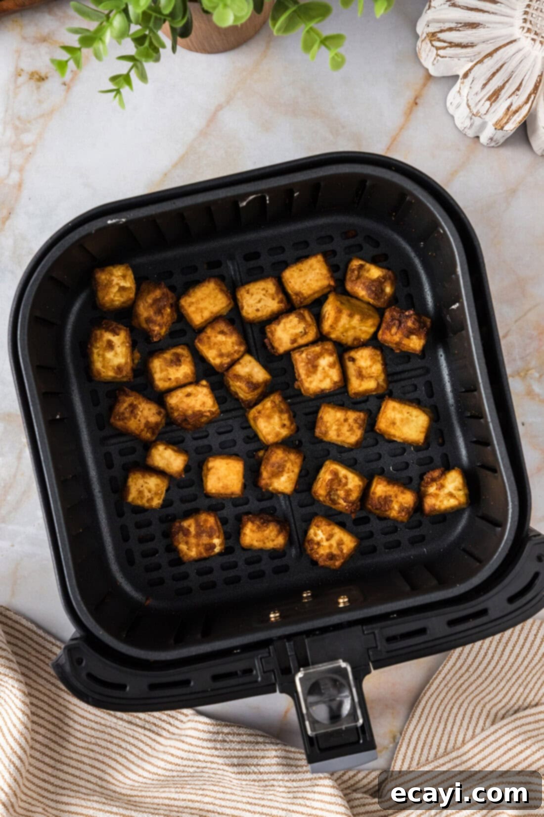 Crispy Air Fryer Tofu 11 Air Fryer Tofu in an Air Fryer Basket, showing its golden-brown texture