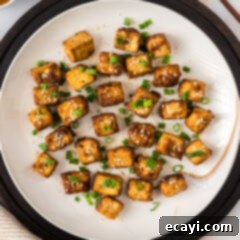 Crispy Air Fryer Tofu 12 Plate of Air Fryer Tofu, garnished with green onions and sesame seeds