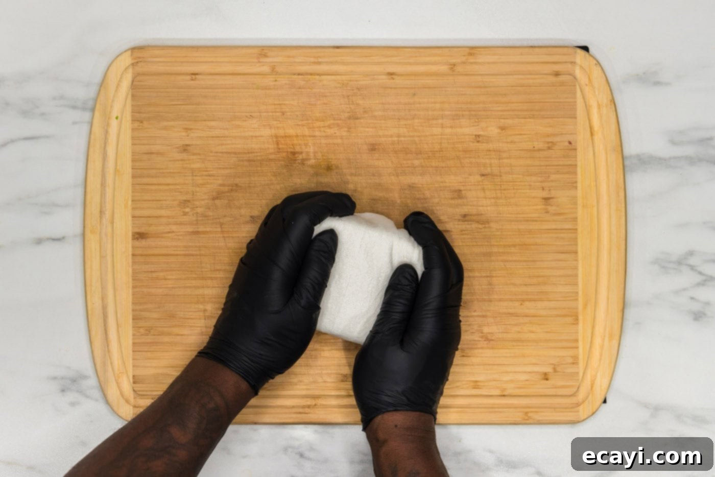 Crispy Air Fryer Tofu 5 squeezing excess moisture out of tofu block using paper towels