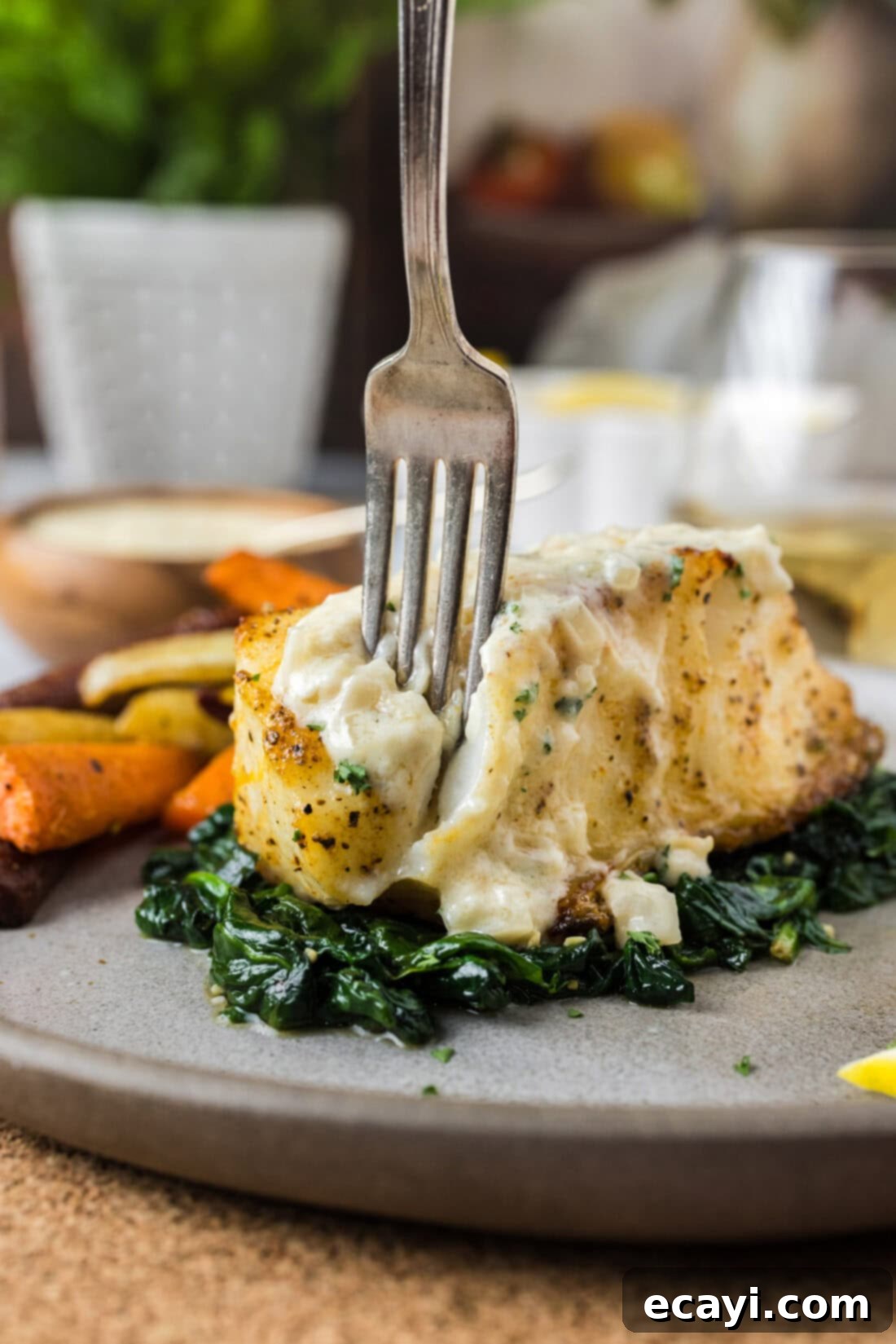 Perfectly Baked Chilean Sea Bass 3 A fork gently pulling apart a perfectly baked Chilean Sea Bass filet, revealing its tender, flaky white flesh.
