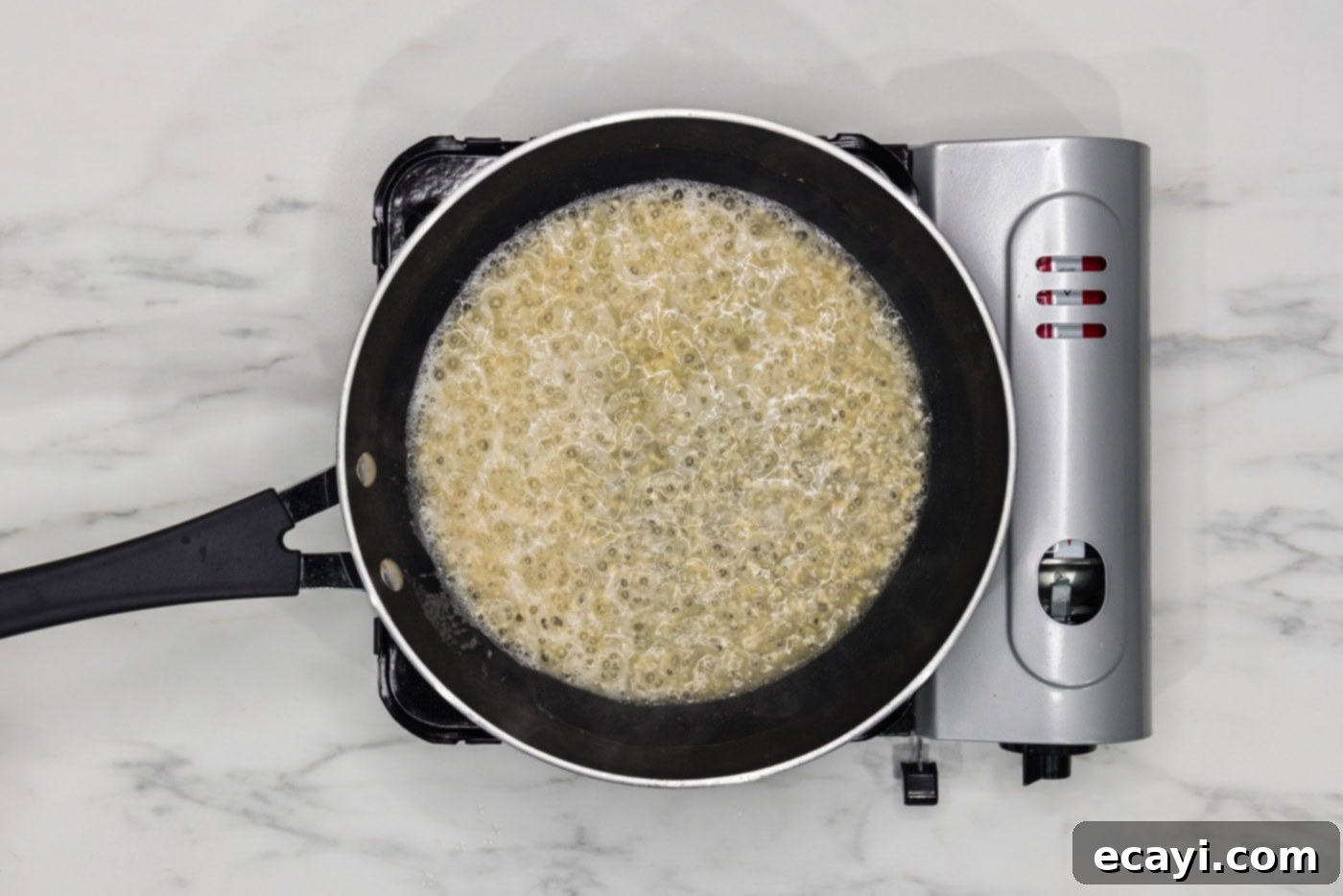 Perfectly Baked Chilean Sea Bass 7 Minced shallots and garlic cooking in butter in a skillet, with white wine being added to deglaze the pan.
