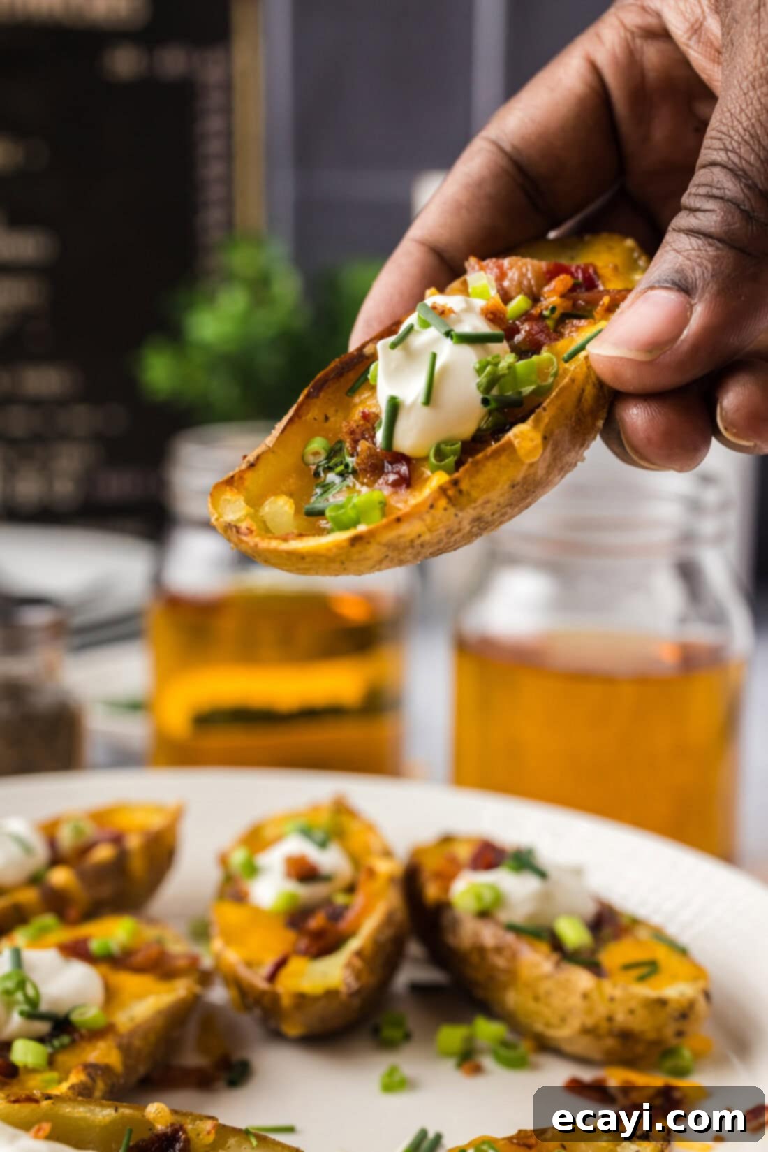 Loaded Potato Boats 3 Hand holding up a Potato Skin