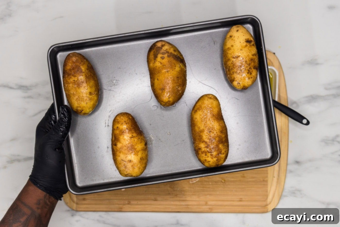 Loaded Potato Boats 6 russet potatoes face down on a baking sheet