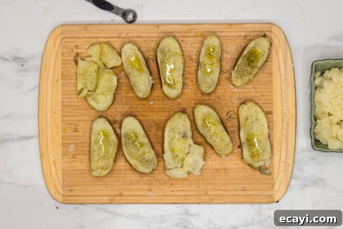 Loaded Potato Boats 8 potato skins on a cutting board seasoned with salt and pepper