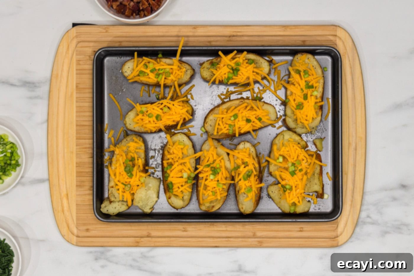 Loaded Potato Boats 9 shredded cheese, green onions, and chives on top of potato skins