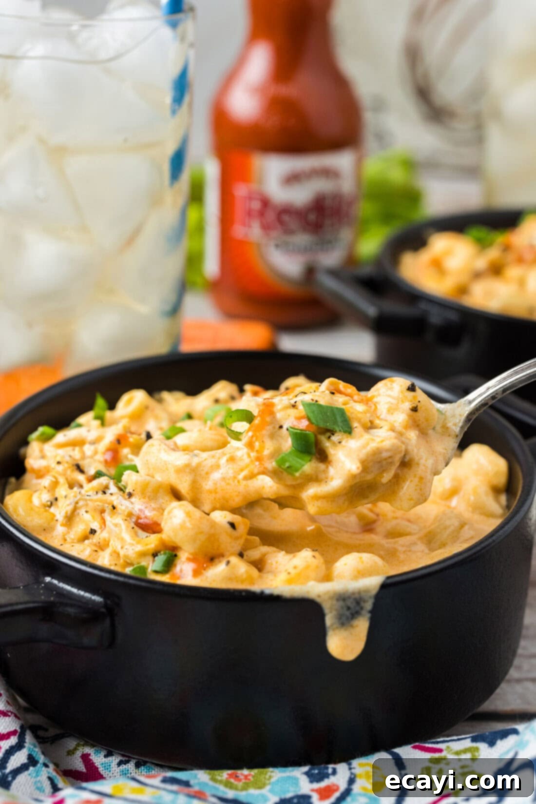 Buffalo Mac Bliss 12 Spoonful of Buffalo Chicken Mac and Cheese being lifted out of a bowl