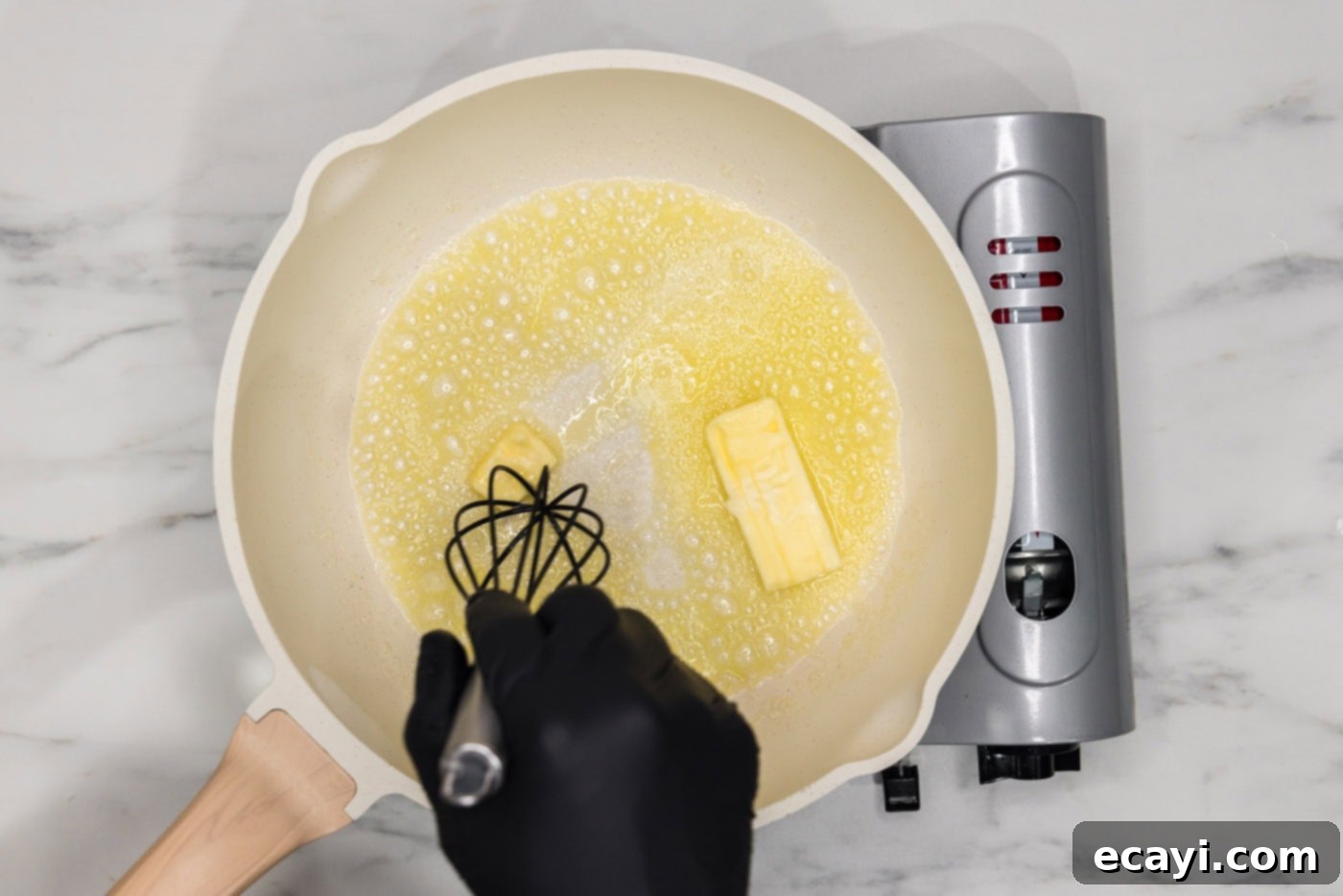 Buffalo Mac Bliss 5 whisking butter in a skillet over heat