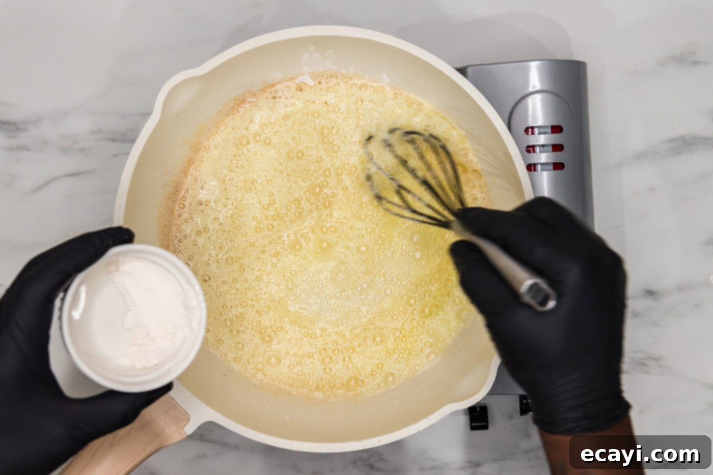 Buffalo Mac Bliss 6 whisking flour into melted butter in a skillet
