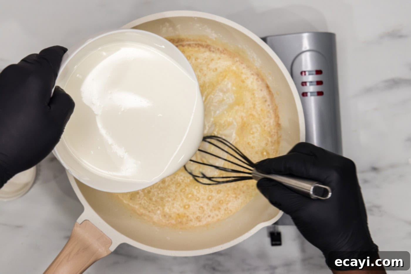 Buffalo Mac Bliss 7 pouring half and half into a skillet with butter and flour mixture
