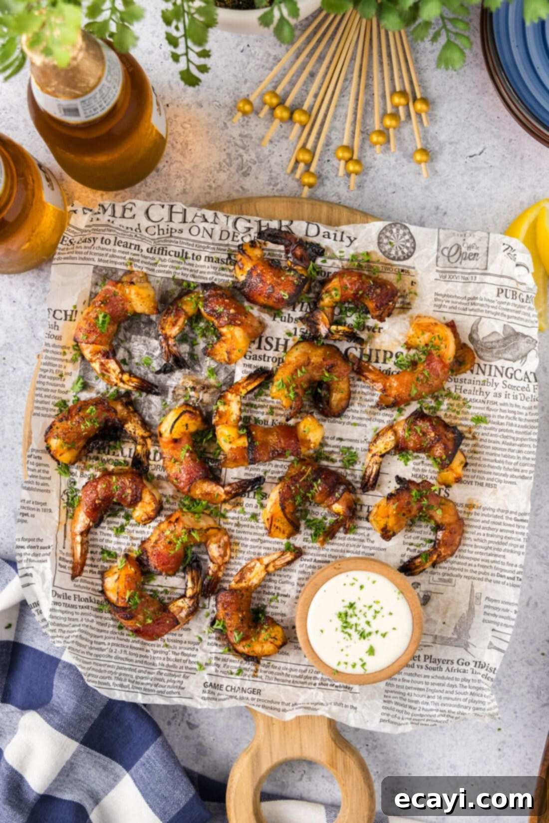 Crispy Air Fryer Bacon Wrapped Shrimp 12 Air Fryer Bacon Wrapped Shrimp arranged on a parchment lined board, garnished and ready to serve.
