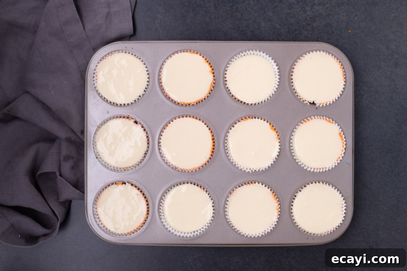Festive Candy Corn Mini Cheesecakes 12 Cream-colored vanilla cheesecake batter as the top layer in cupcake liners, completing the candy corn layered look.