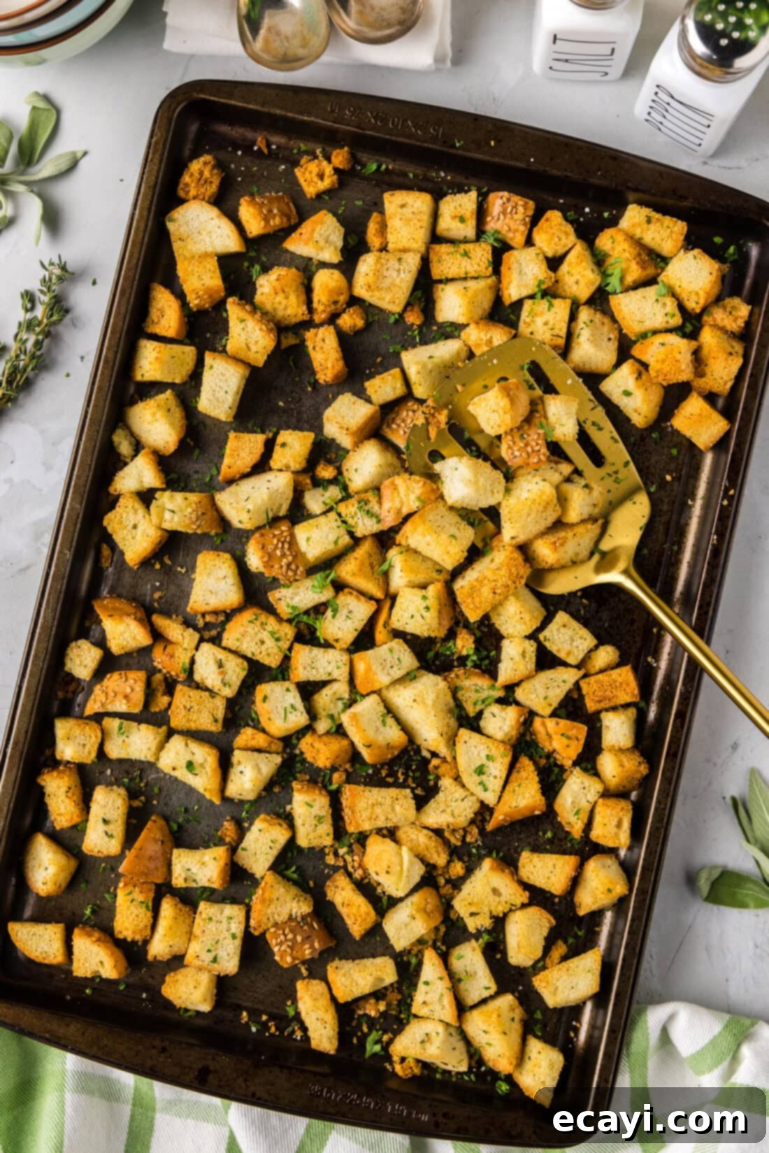 Crispy Golden Croutons 2 Homemade Croutons on a baking sheet with a spatula