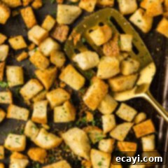 Crispy Golden Croutons 12 Close up photo of a spatula on a baking sheet of Homemade Croutons
