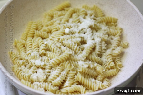 Savory Chicken and Pepper Pasta 14 A close up of a bowl filled with Rotini pasta and topped with Parmesan cheese.