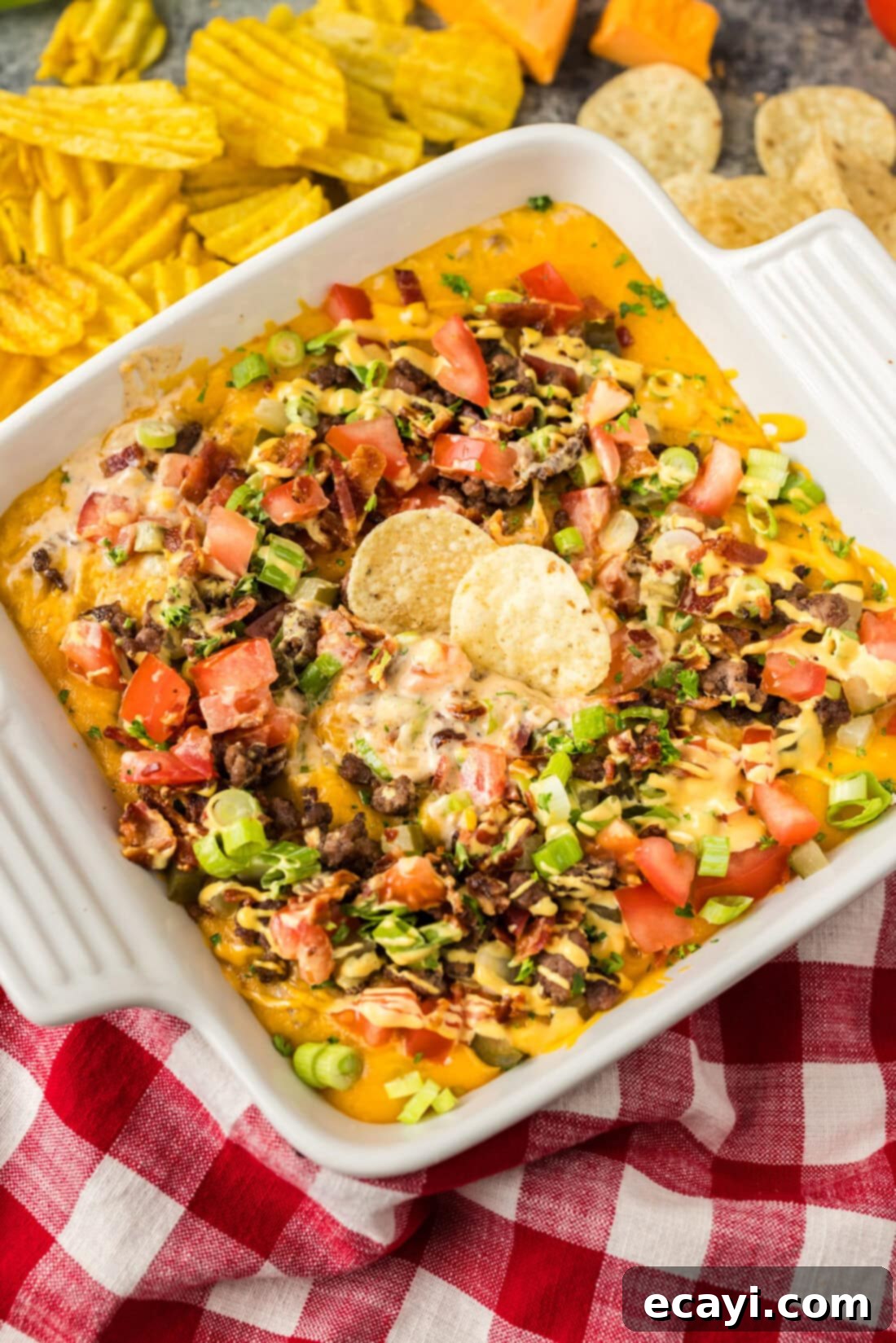 Loaded Cheeseburger Dip 3 Dish of Cheeseburger Dip with two chips in it