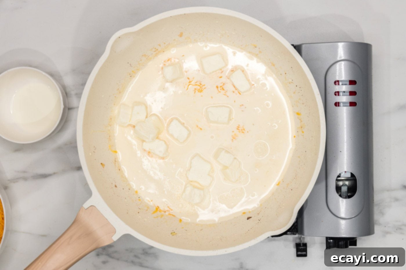 Loaded Cheeseburger Dip 7 cream cheese in a skillet with heavy cream and onions