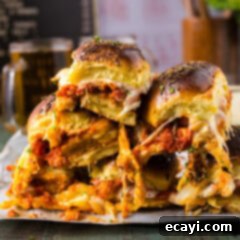 Cheesy Chicken Parmesan Sliders 13 Close up photo of a stack of Chicken Parmesan Sliders with golden-brown buns and melted cheese