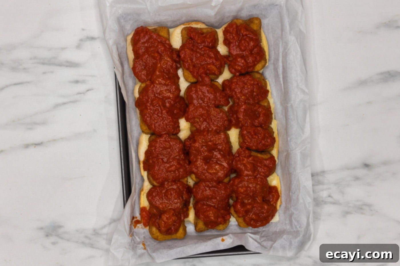 Cheesy Chicken Parmesan Sliders 8 Marinara sauce generously added on top of chicken nuggets and cheese layers