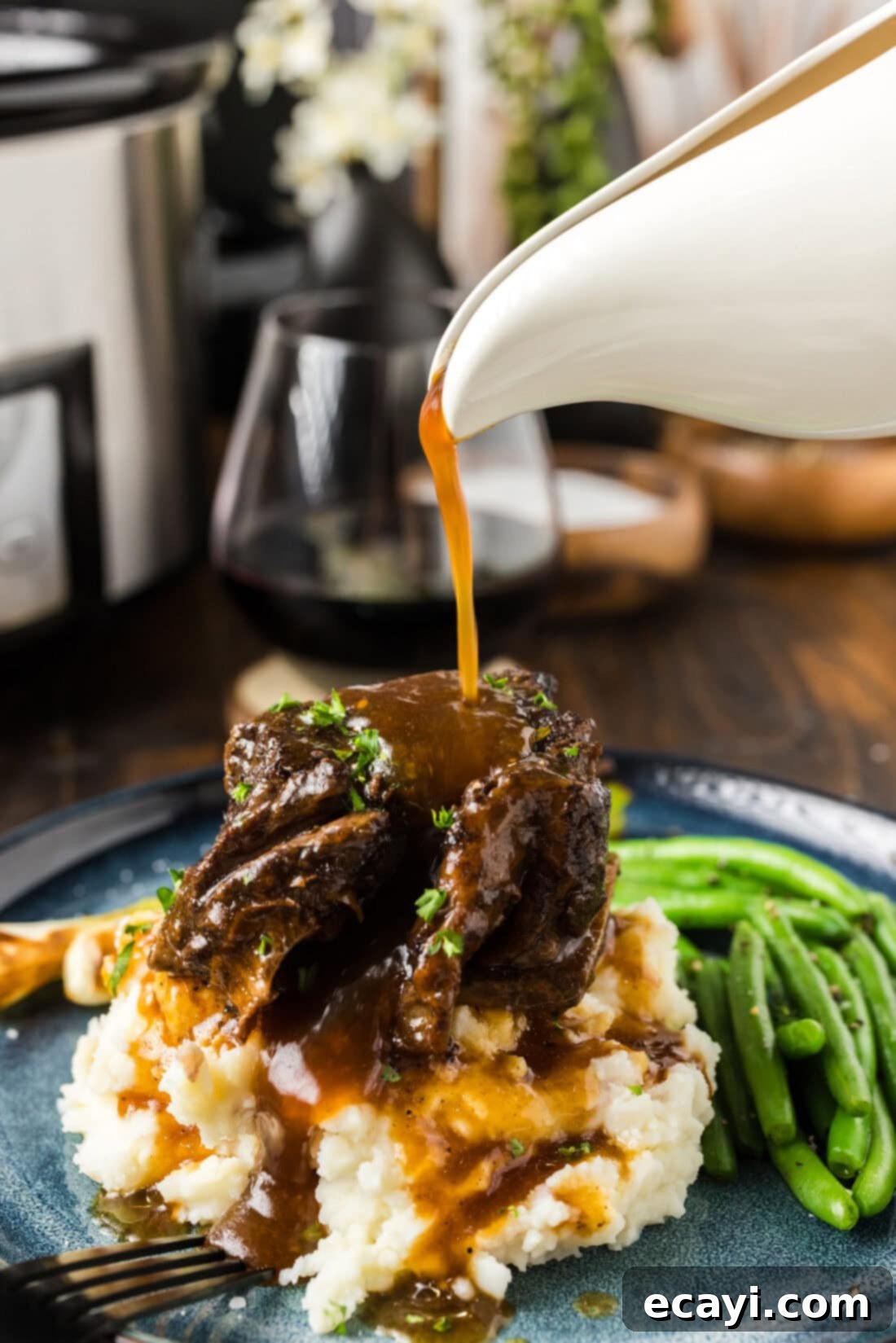 Rich & Tender Slow Cooker Short Ribs 3 Gravy being poured over a Crockpot Beef Short Rib
