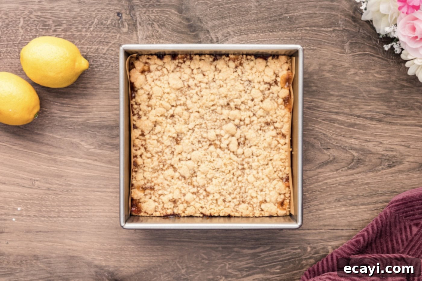 Zesty Lemon Crumble Bars 10 Baked Lemon Streusel Squares in a 9x9 inch pan, showing the golden-brown streusel topping and set lemon curd.