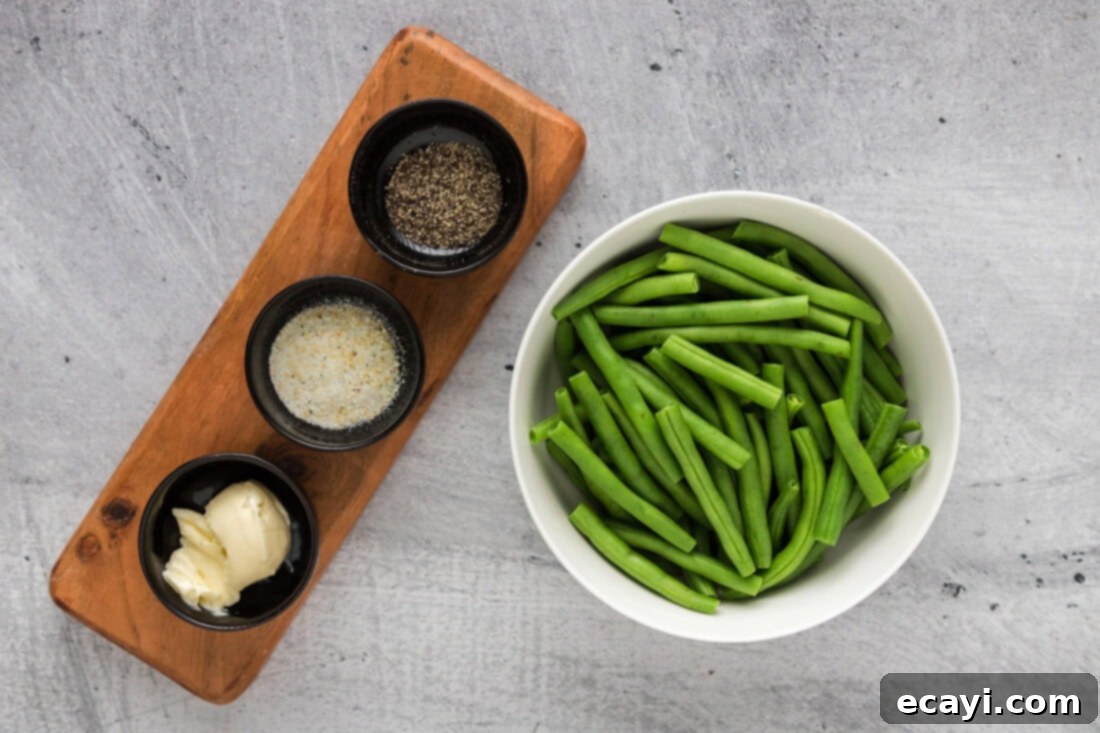 Perfect Instant Pot Green Beans 4 Fresh green beans, butter, and seasonings laid out as ingredients for the Instant Pot recipe