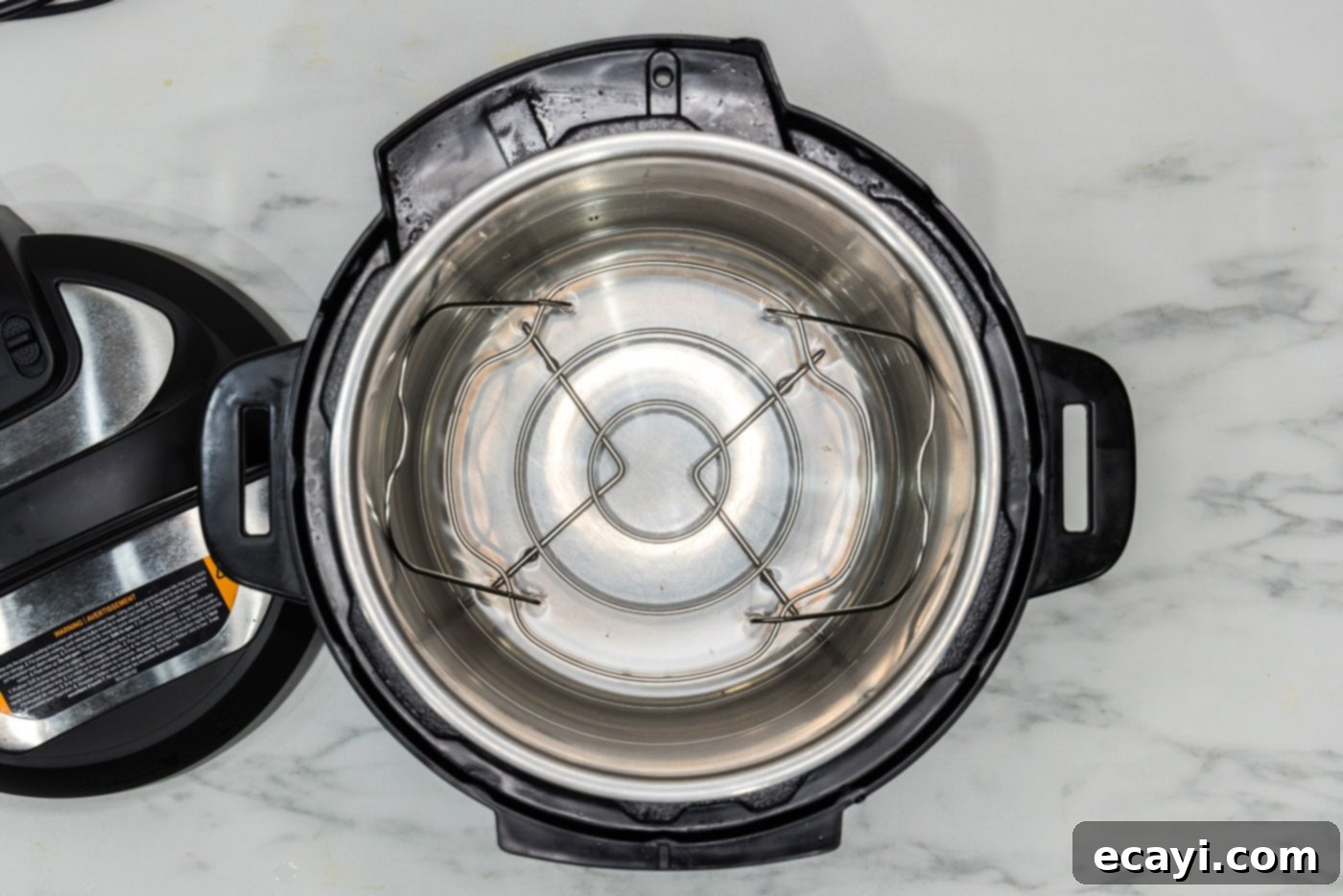 Perfect Instant Pot Green Beans 5 A view of water at the bottom of an Instant Pot with a metal trivet inserted