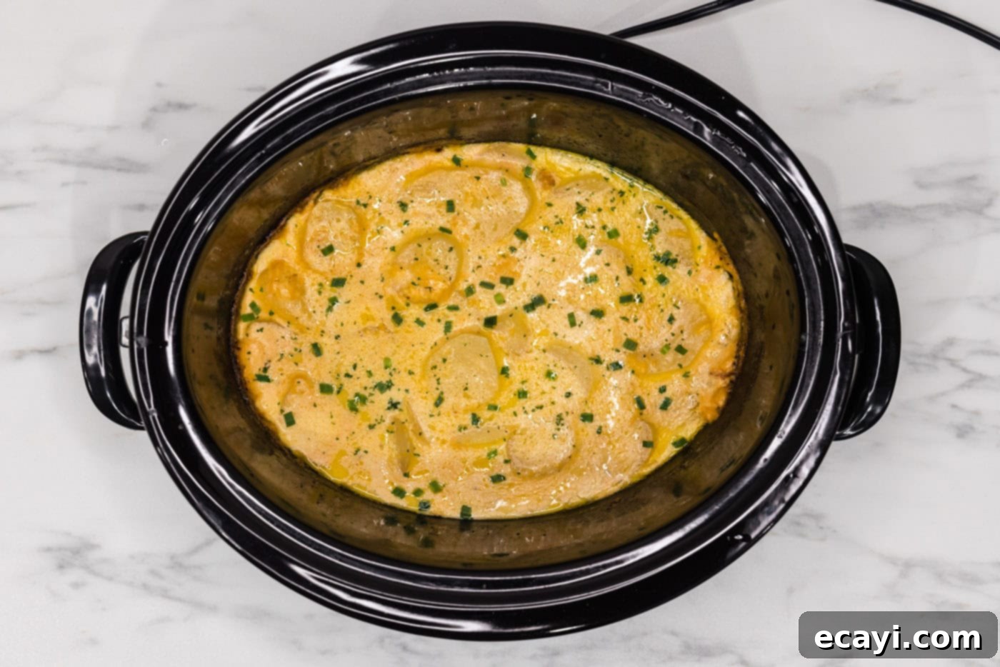 Set It and Forget It Scalloped Potatoes 13 overhead shot of cheesy crockpot scalloped potatoes