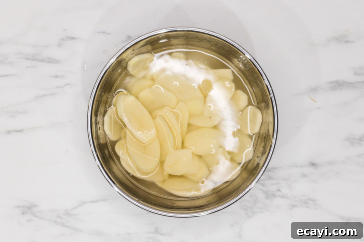 Set It and Forget It Scalloped Potatoes 6 thinly sliced potatoes in a bowl of water