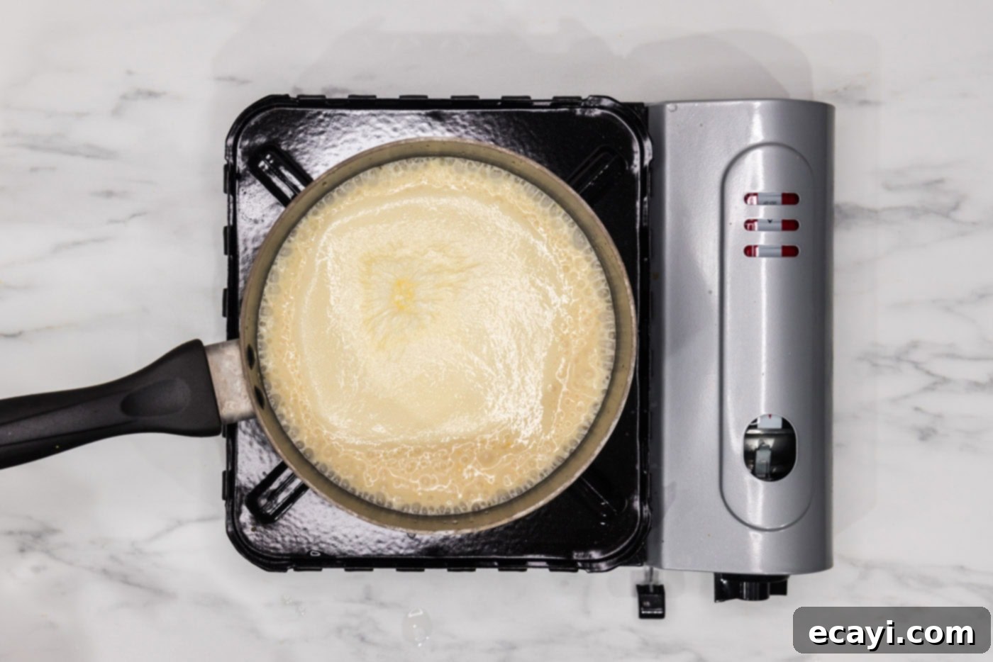 Set It and Forget It Scalloped Potatoes 9 cheese sauce in a saucepan for scalloped potatoes