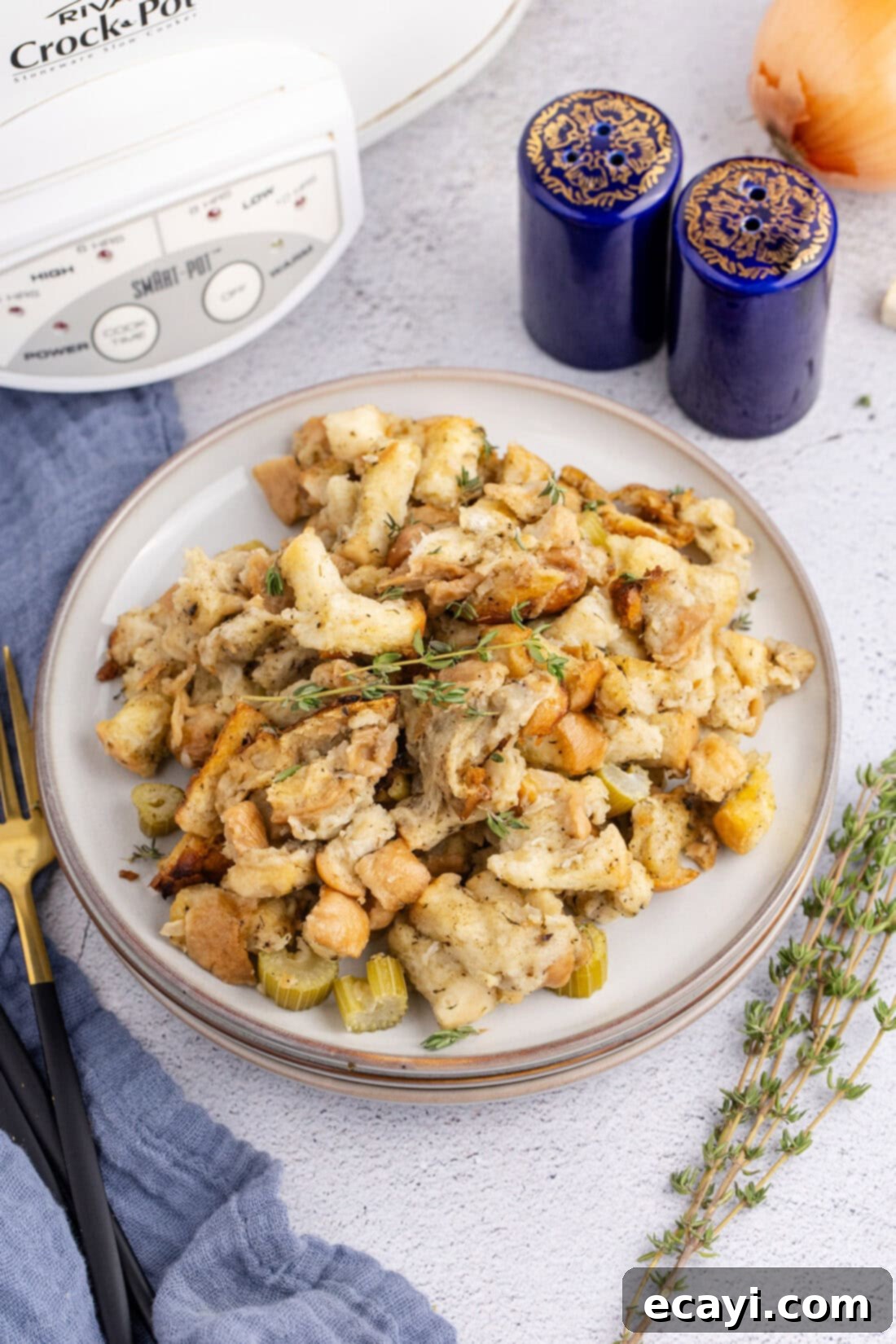 Easy Crockpot Stuffing 12 Plate of Crockpot Stuffing with a sprig of fresh thyme, ready to be enjoyed.