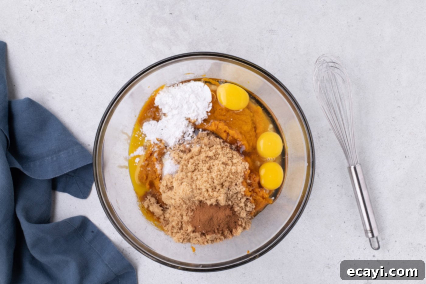 Family Sized Sheet Pan Pumpkin Pie 11 pumpkin puree, brown sugar, egg, egg yolk, cornstarch, and pumpkin pie spice in a bowl