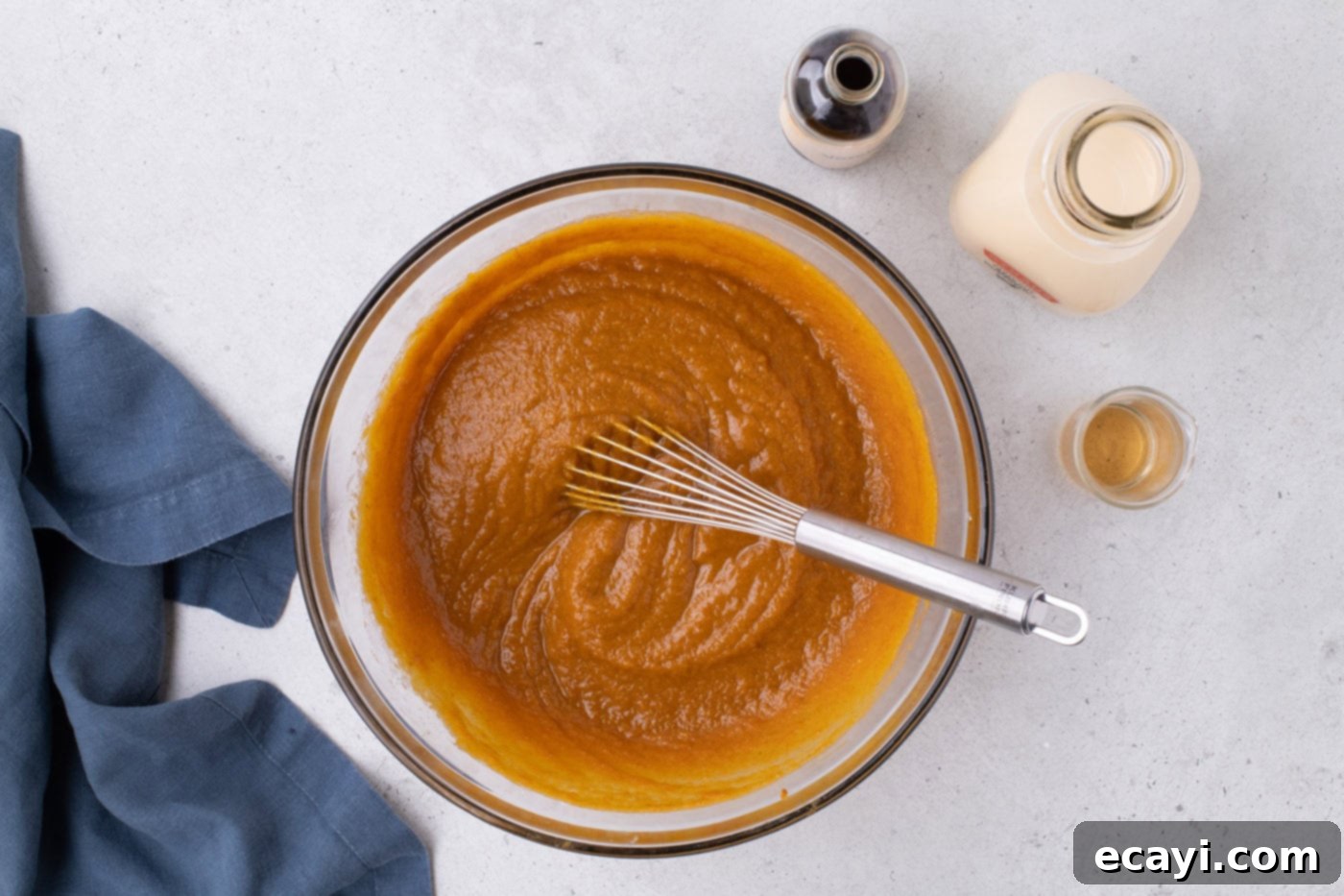 Family Sized Sheet Pan Pumpkin Pie 12 pumpkin pie filling in a bowl with a whisk