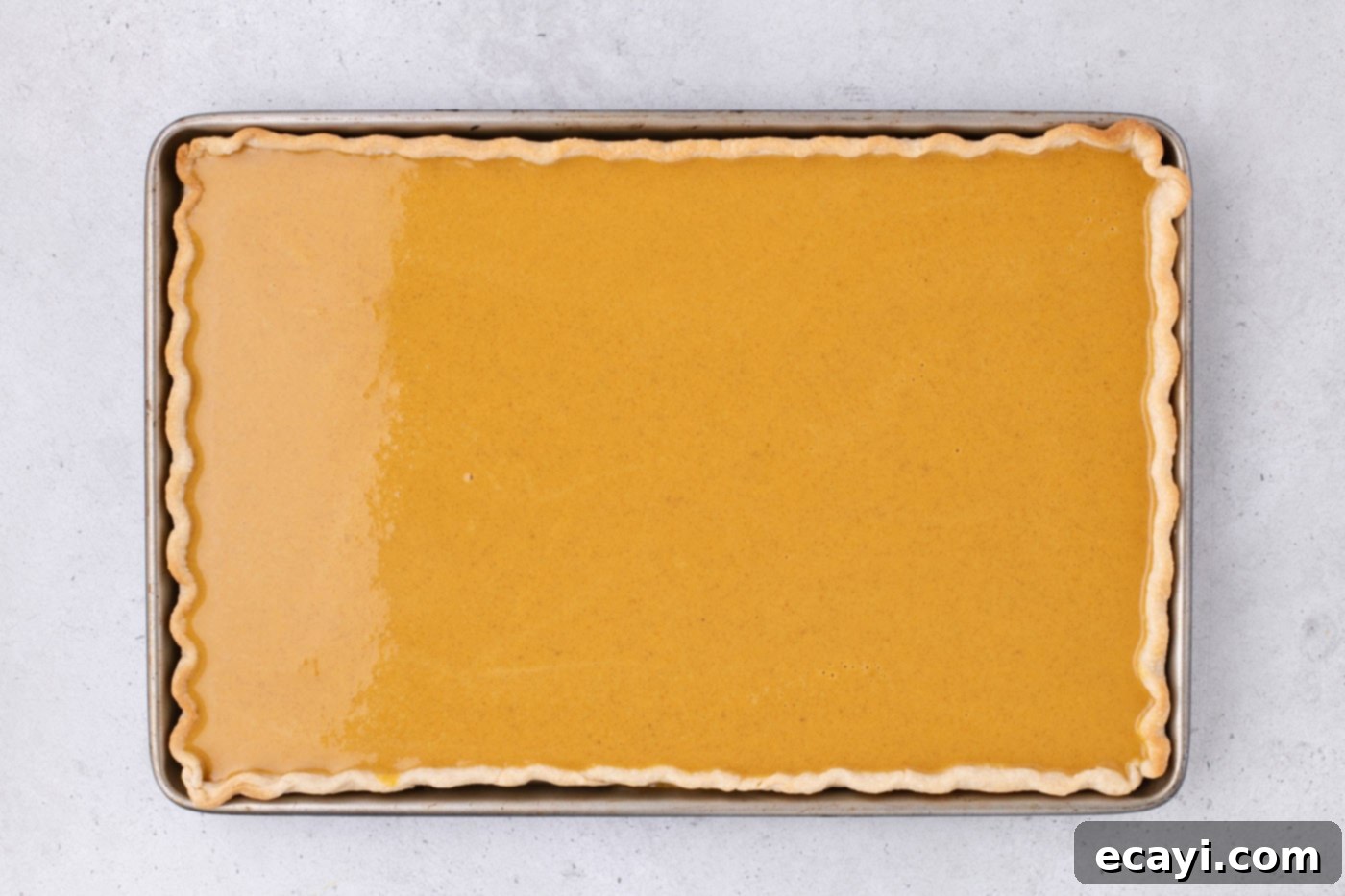Family Sized Sheet Pan Pumpkin Pie 16 pumpkin pie filling over crust in a jelly roll pan