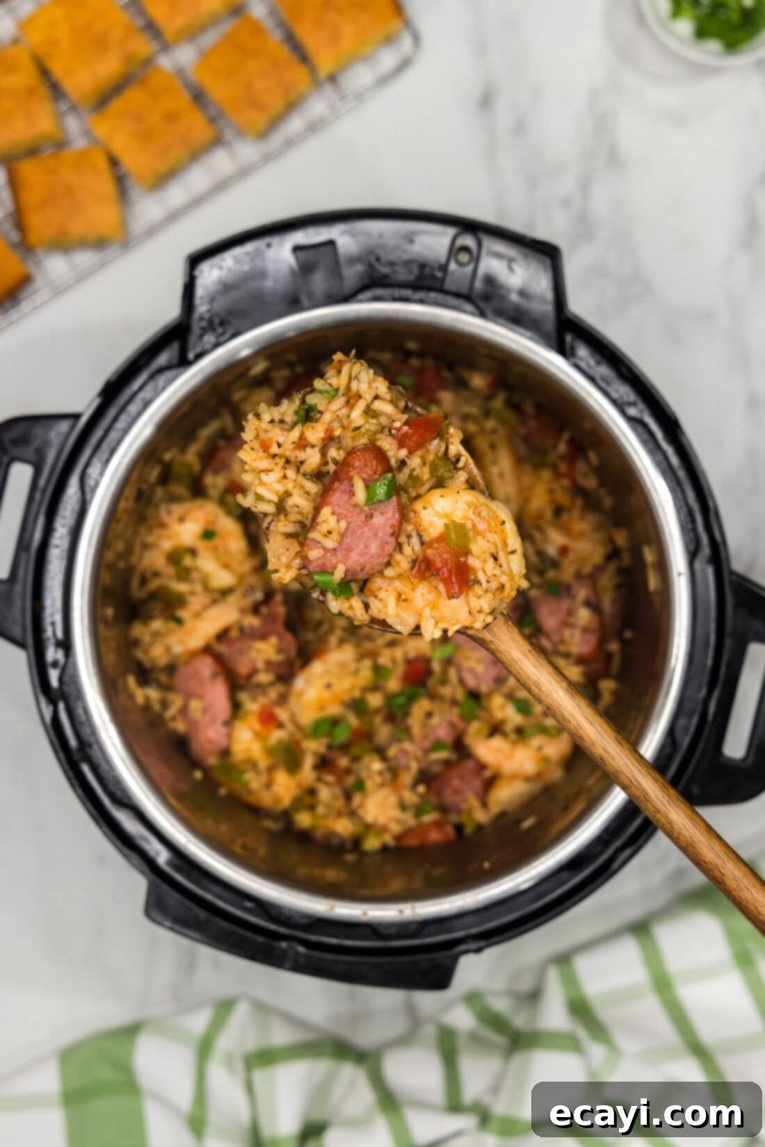 Easy Instant Pot Jambalaya 13 Heaping spoonful of Instant Pot Jambalaya held above an Instant Pot