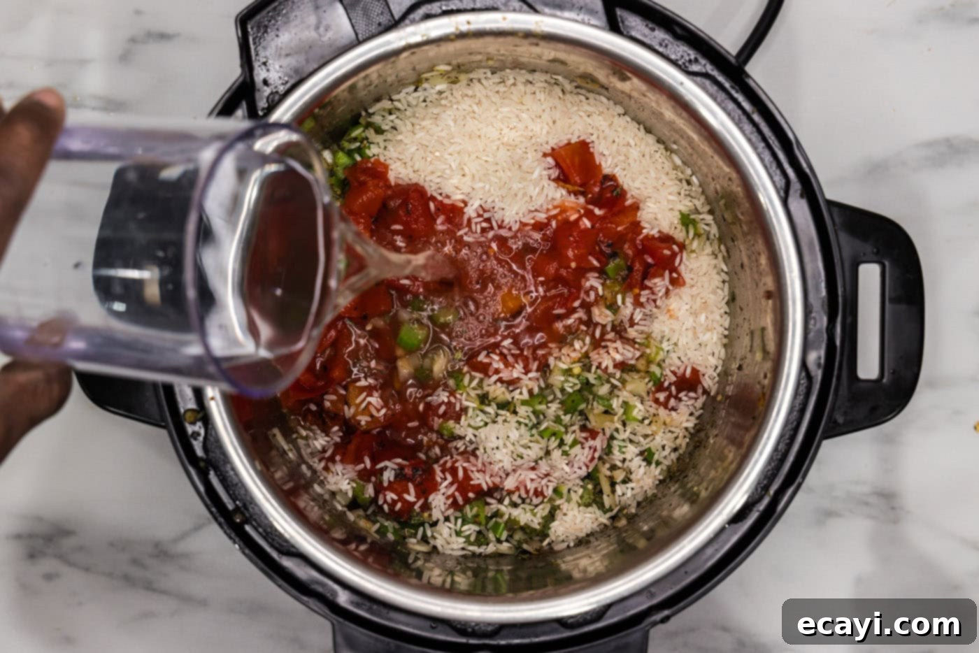 Easy Instant Pot Jambalaya 10 pouring water into instant pot with jambalaya ingredients