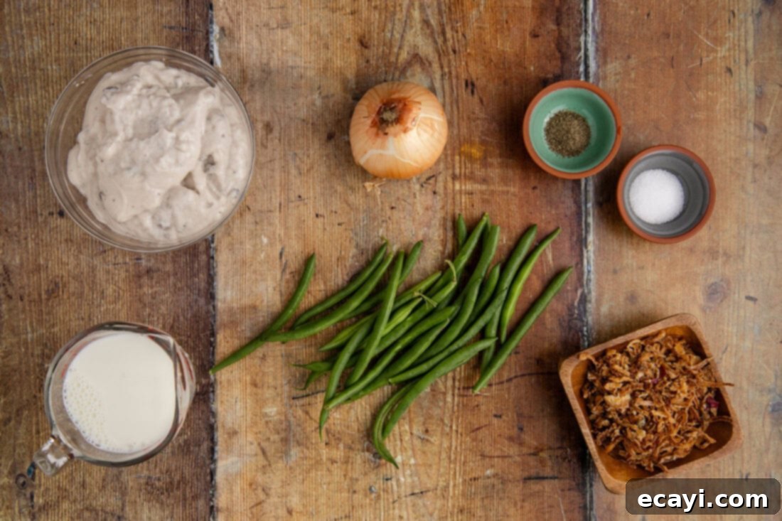 Effortless Crockpot Green Bean Bake 4 Ingredients for Crockpot Green Bean Casserole laid out on a table, including fresh green beans, cans of soup, a carton of milk, and French fried onions.