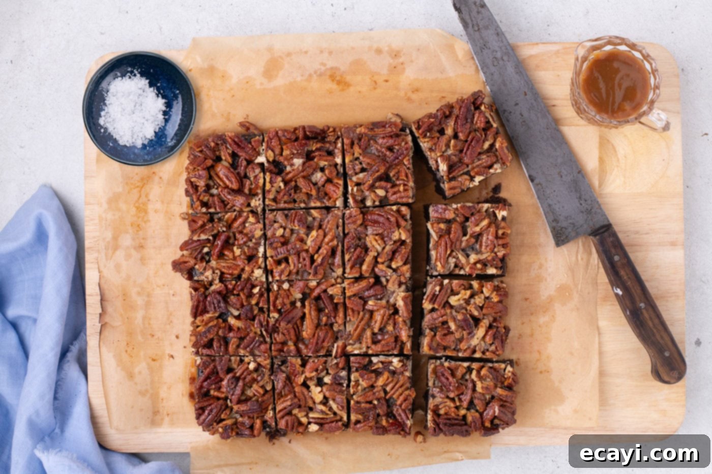 Decadent Pecan Pie Brownies 10 pecan pie brownies cut into perfect squares on a baking sheet, ready for garnishing and serving