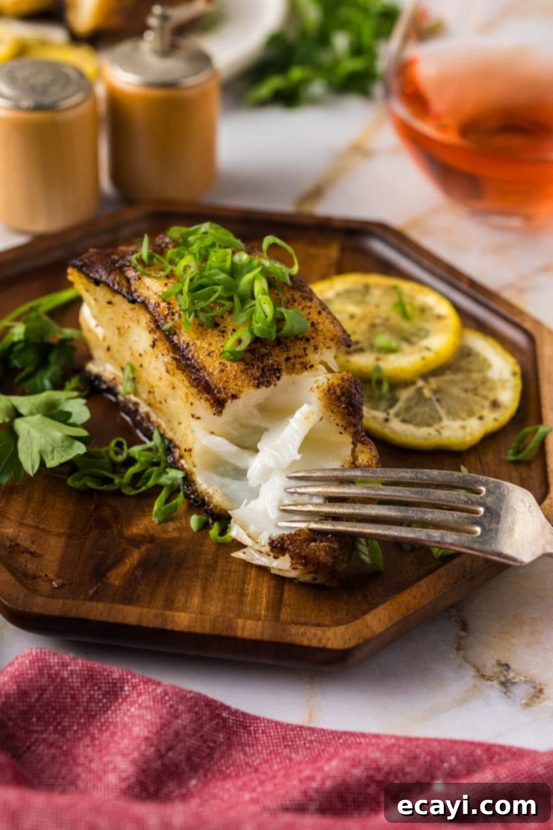 Crisp Skin Pan Seared Chilean Sea Bass 2 Fork breaking apart a Pan Seared Chilean Sea Bass filet