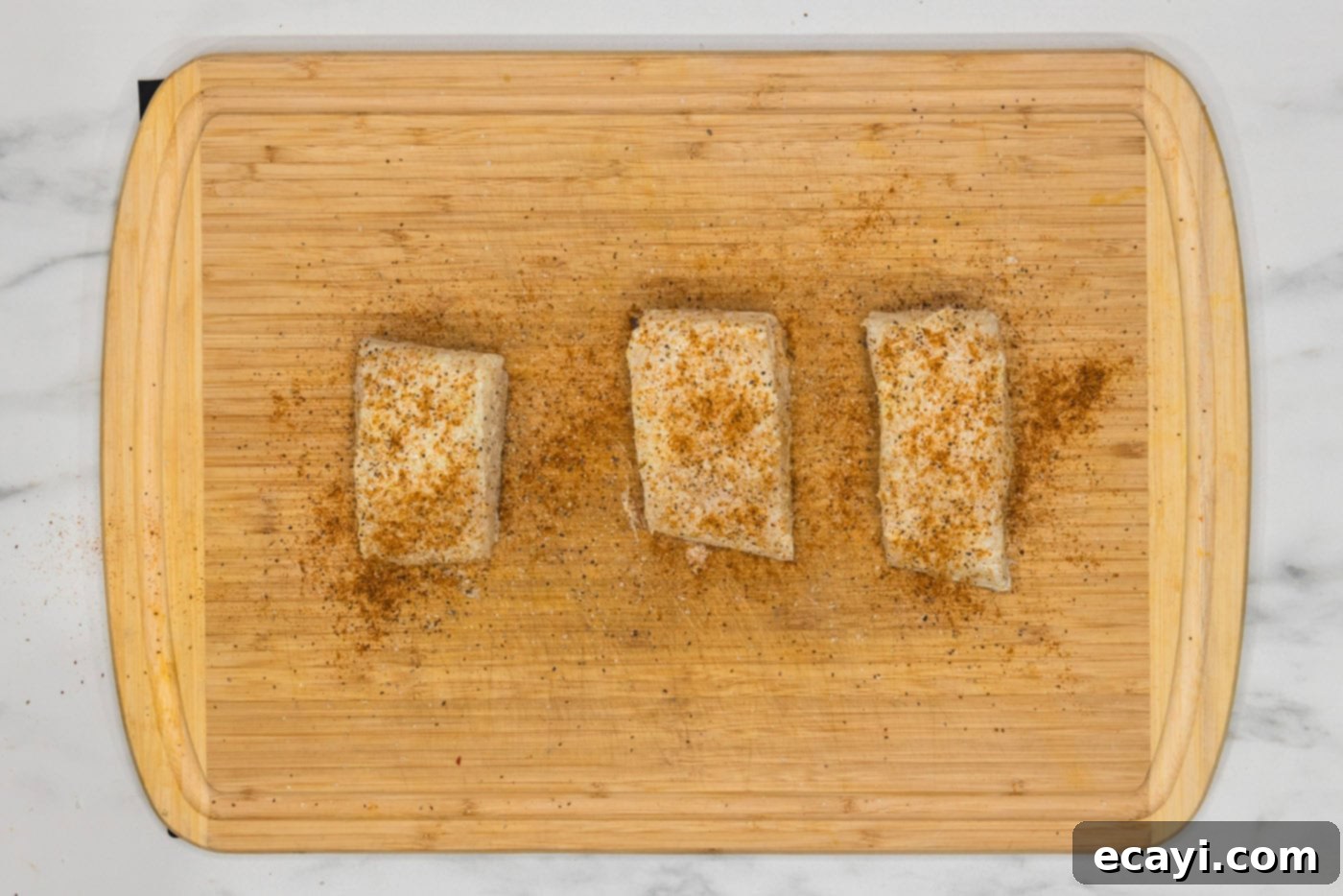 Crisp Skin Pan Seared Chilean Sea Bass 7 seasoned chilean sea bass filets on a cutting board