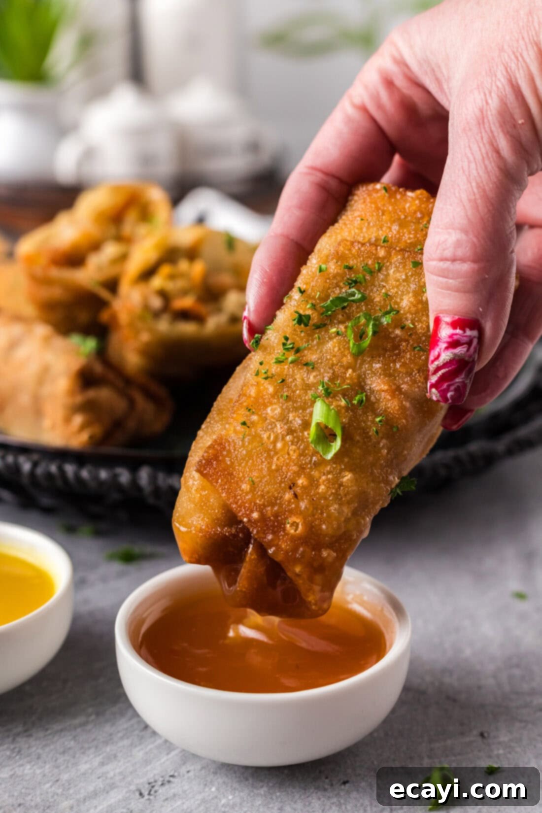 Prawn Spring Rolls 3 Shrimp Egg Roll being dipped into sweet and sour sauce