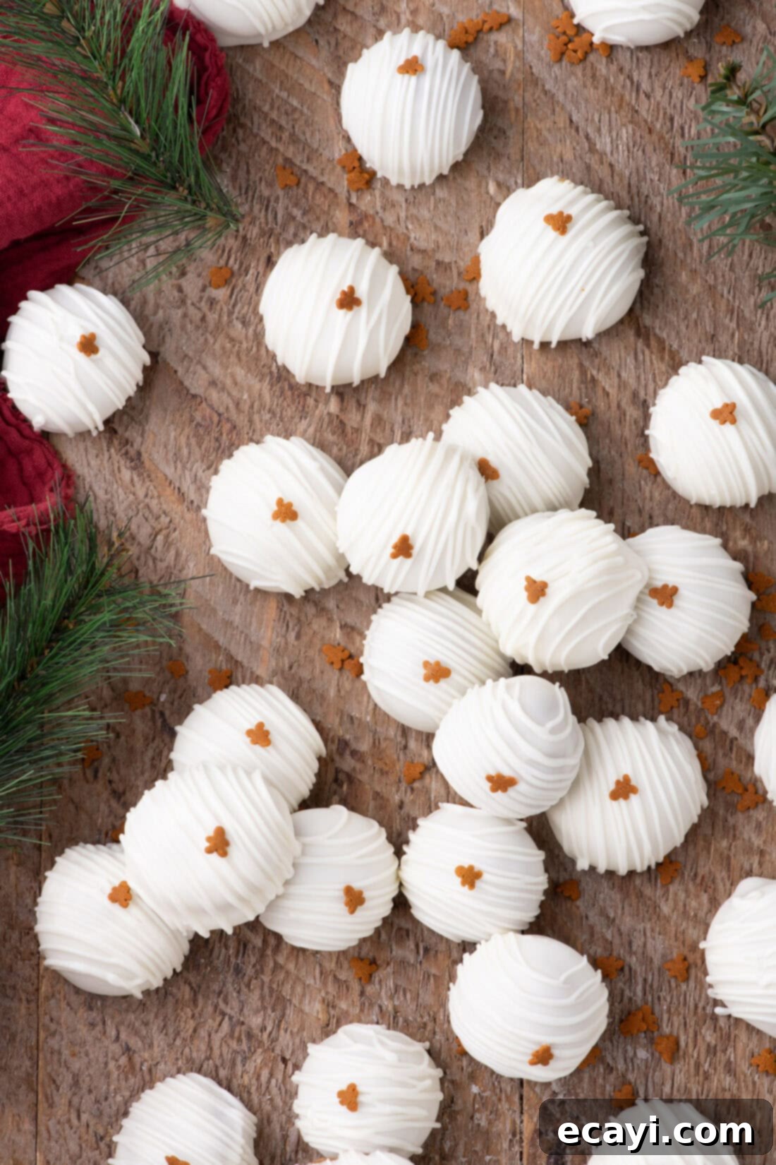 Gingerbread Oreo Bliss Bites 3 Gingerbread Oreo Truffles resting on a rustic wooden board, showcasing their festive appeal