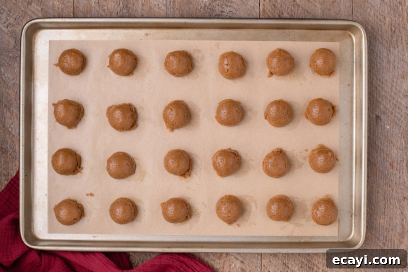 Gingerbread Oreo Bliss Bites 8 Gingerbread Oreo truffle balls neatly arranged on a parchment-lined baking sheet, ready for freezing