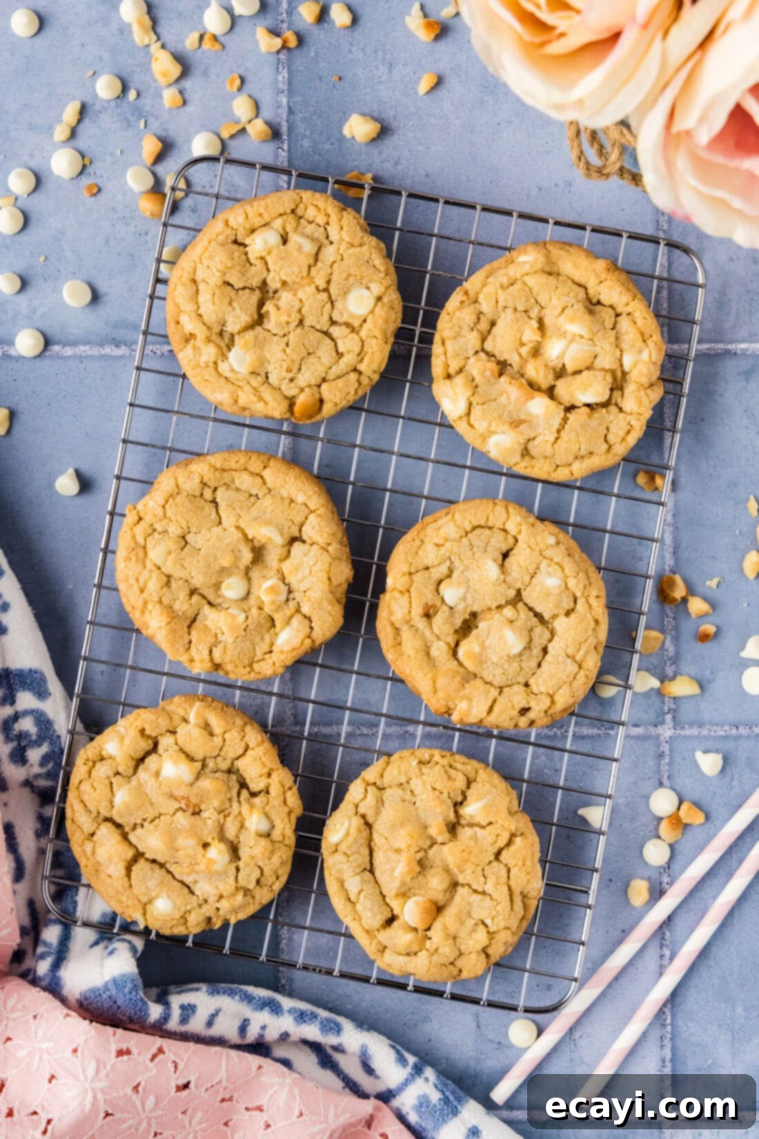 Decadent White Chocolate Macadamia Delights 11 Beautifully arranged White Chocolate Macadamia Nut Cookies cooling on a wire rack, showcasing their perfect texture and golden-brown hue.