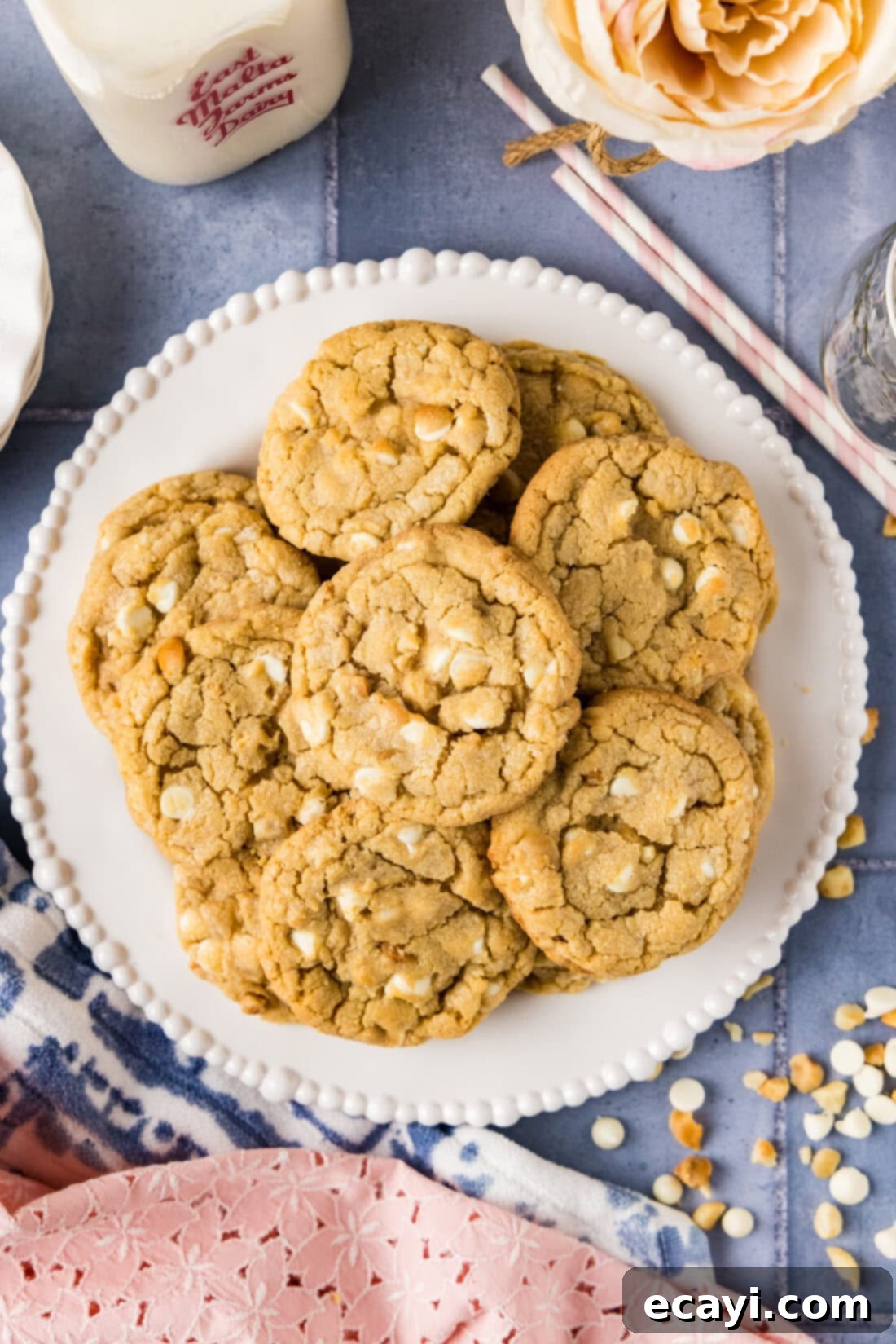 Decadent White Chocolate Macadamia Delights 3 A plate generously filled with freshly baked White Chocolate Macadamia Nut Cookies, each one perfectly golden with visible white chocolate chips and macadamia nuts, ready to be enjoyed.