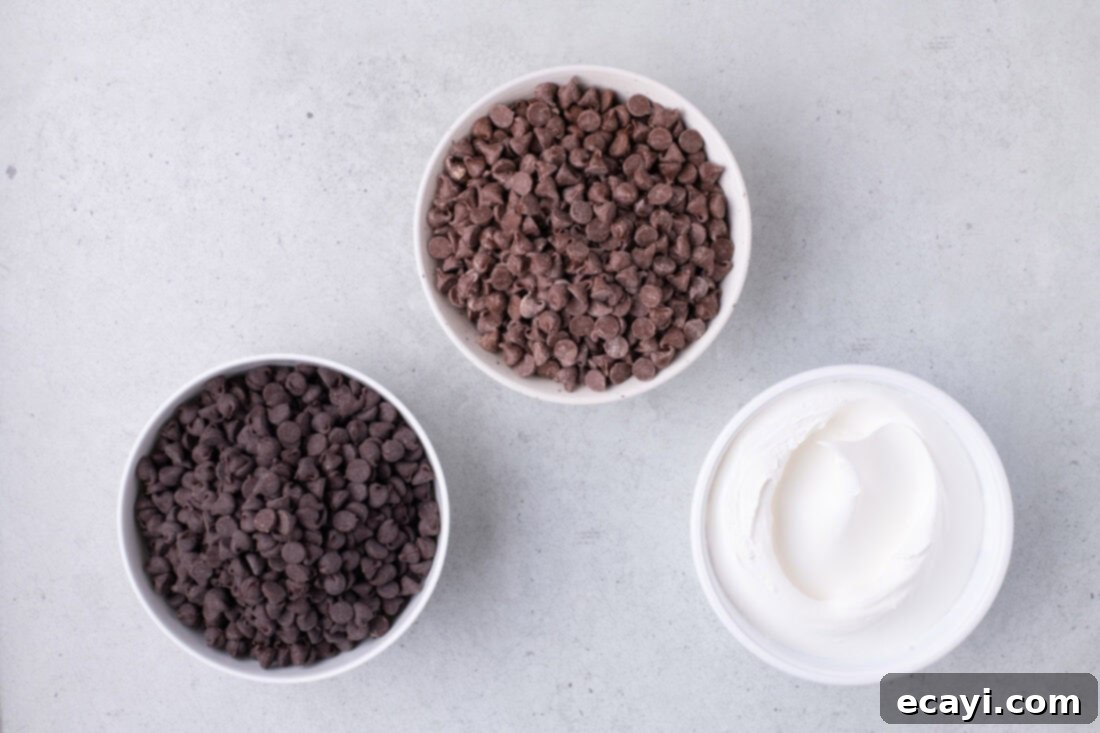 Cool Whip Treats 4 A flat lay of the three main ingredients for Cool Whip Candy: milk chocolate chips, semi-sweet chocolate chips, and a tub of Cool Whip.
