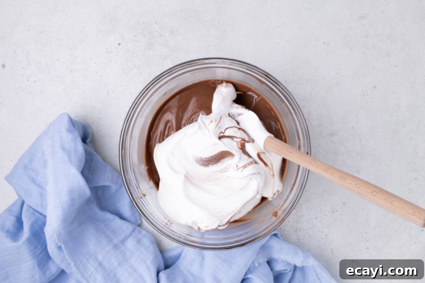 Cool Whip Treats 6 Room temperature Cool Whip being folded into whipped melted chocolate in a bowl.